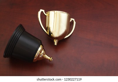 Broken Golden Champion Trophy Cup On Wooden Background With Copy Space