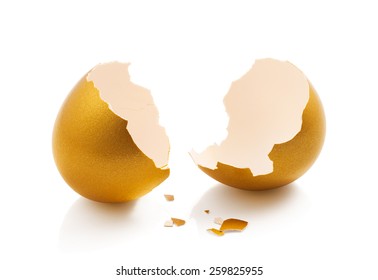 Broken Golden Egg Isolated On White Background