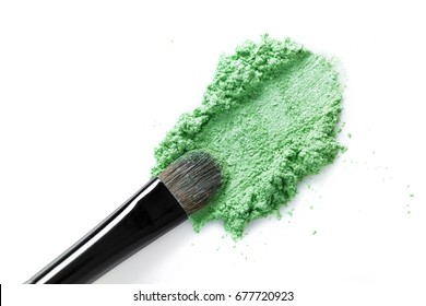 Broken Green Eye Shadow And Makeup Brush Isolated On The White Background