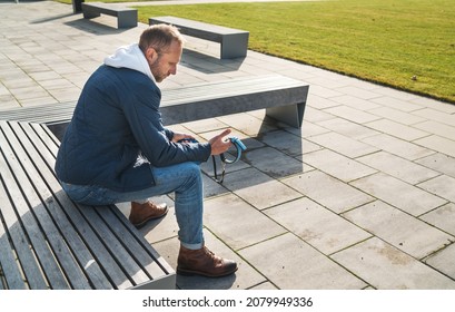 Broken With Grief Man Grieving Dog Owner Holding The Lovely Pet Collar With A Leash And Deep Weeping About Animal Loss. Home Pets Relatives And Love Concept.