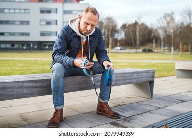 Broken With Grief Man Grieving Dog Owner Holding The Lovely Pet Collar With A Leash And Deep Weeping About Animal Loss. Home Pets Relatives And Love Concept.