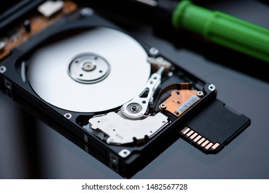 Broken Hard Disk And Memory Card On The Desk.