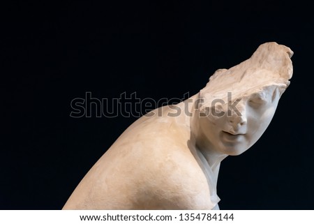Broken head of marble statue of young man
