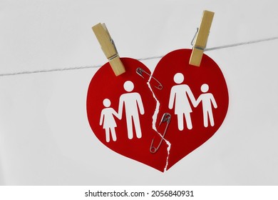 Broken Heart With Family Joined With Safety Pin And Attached On Clothesline - Concept Of Saving Marriage And Family