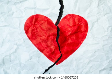 Broken Heart, Loss, Ended Relationship Or Cheating Concept. Sign Of Heart Drawn With A Marker Pen On A Piece Of Crumbled Torn Paper.