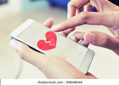 Broken Heart On Smart Phone Concept Background