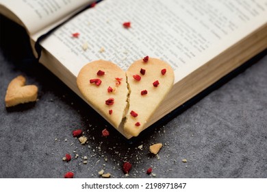 A Broken Heart Shaped Cake On An Open Book, Like Love That Will Break When You Use Logic Too Much