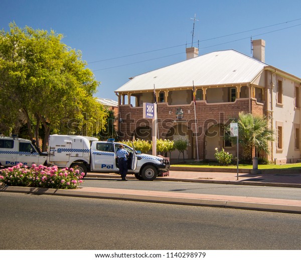 BROKEN HILL, NEW SOUTH WALES,
AUSTRALIA, MARCH 2018 - Police station and cars, with uniformed
policewoman  in the city of Broken Hill, New South Wales,
Australia