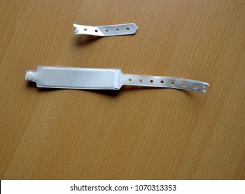 Broken Hospital Bracelet On Wooden Background