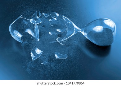 broken hourglass. waste of time. end of opportunity. stop measuring hours. shards of glass. shattered hope