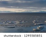 Broken Ice on frozen Kaktovik Lagoon Alaska with Brooks Range mountains