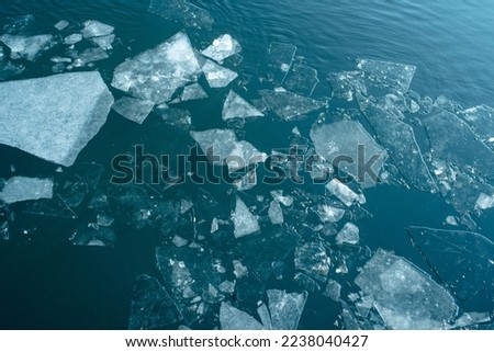 Broken ice in the water. Natural texture