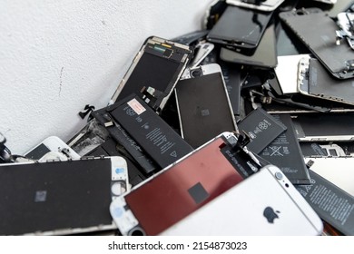 Broken IPhone Apple Phone Screens And Used Rechargeable Batteries In Recycling Repair Shop, RUSSIA - July 27, 2020.