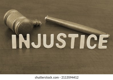 Broken judge gavel and word injustice. Concept of iniquity, injustice and lawlessness.	 - Shutterstock ID 2113594412