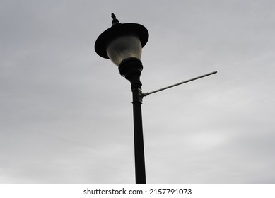 Broken Lamp Post With Light Sitting Crooked At The Top