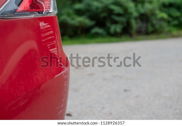 The broken lamp of the red\
sedan