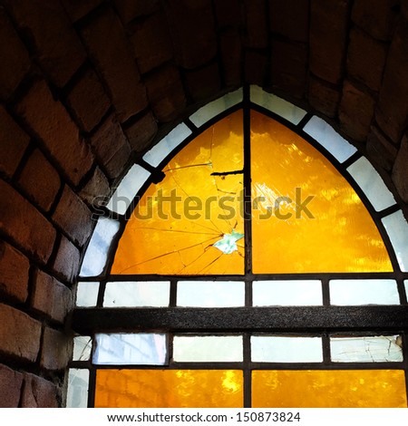 A broken leadlight window of a gothic church