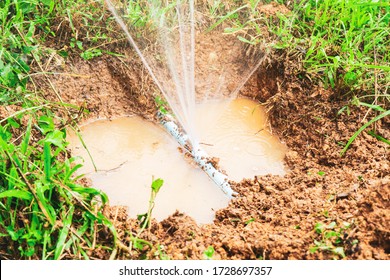 Broken Leak Pvc Water Pipe Busting With Water Leakage, Under Hole Dirt In Ground, Representing Broken Disruptive Explosion, Water Spraying Out Chaotically, Plumbing Construction Fixing Repairing