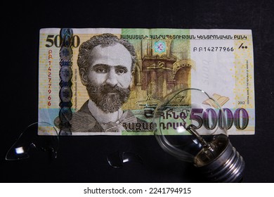 Broken light bulb with pieces of glass on Armenian dram. Concept of electricity prices and the electricity crisis in Armenia - Powered by Shutterstock