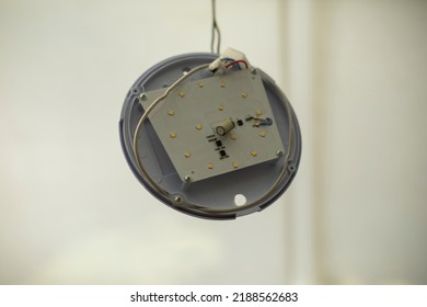 Broken Light Fixture. Torn Wire. Round LED Light Is Ruined. Vandalism In Detail.