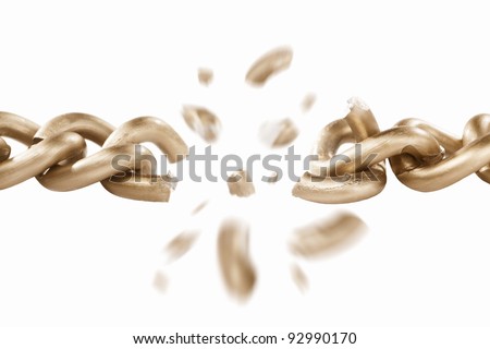 Broken link of golden chain with blurry movement of the scattered pieces, isolated against white background. Small depth of field