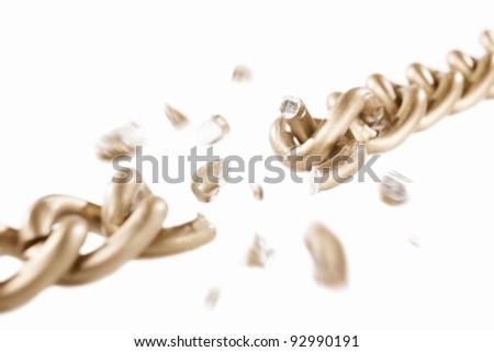 Broken link of golden chain with blurry movement of the scattered pieces, isolated against white background. small depth of field