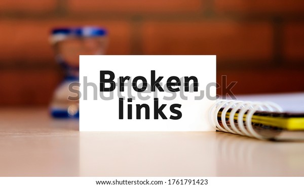 Broken links text n white sheet with notepad\
and hourglass