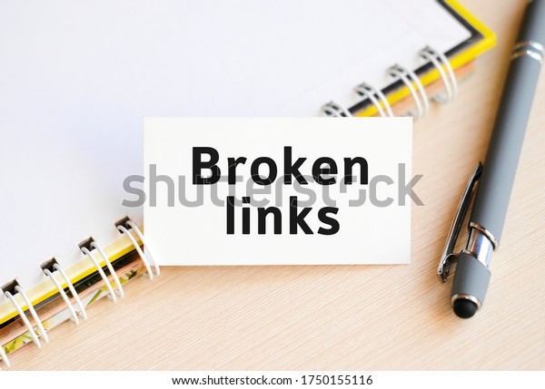 Broken links - text on a notebook with a spring\
and a gray handle