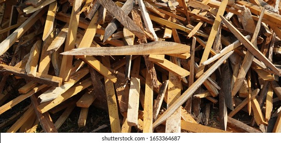 Broken long chunks of tree trunk. Close up broken pieces of wood. Pine timber wood chip. Broken into pieces and splinters solid tree trunk, close-up from the place of harvesting wood.