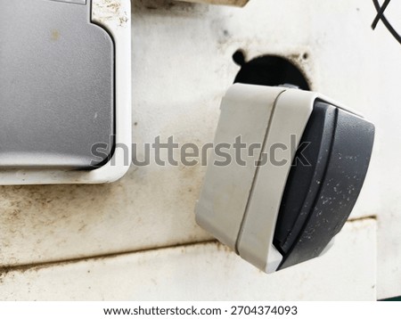 A broken and loose electrical outlet switch indicates damage to public facilities in the park