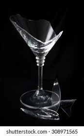 Broken Martini Glass And Debris On A Black Background