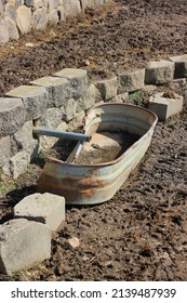 Broken Metal Water Trough Standing In The Cow Pasture.