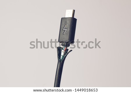 Broken micro USB phone charging cable closeup