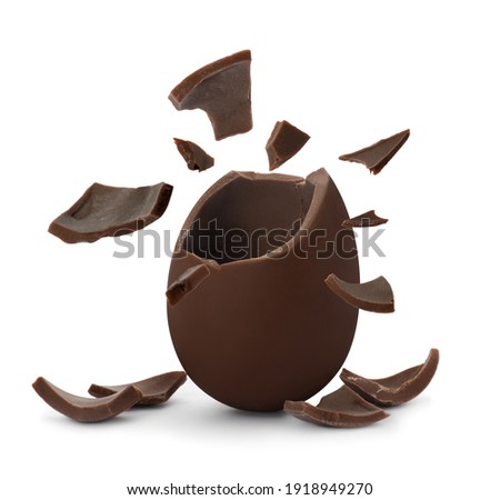 Broken milk chocolate egg on white background
