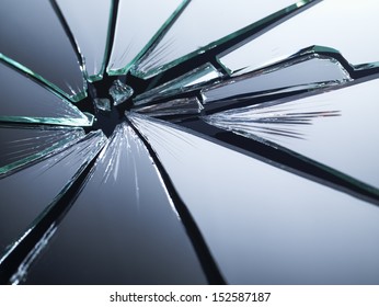 Broken Mirror Shattered In Many Pieces.