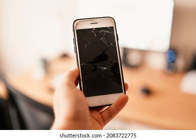 Broken Mobile Phone Screen After Fall Down. Cell Phone Damaged On The Hard Ground, Ready To Service.