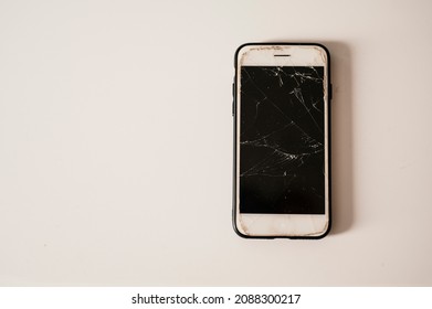 Broken Mobile Phone Screen After Fall Down. Cell Phone Damaged On The Hard Ground, Ready To Service.