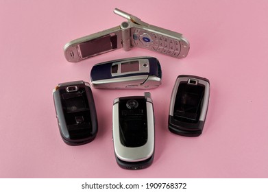 Broken Mobile Phones, Recycling Technology, Early 2000s On Pink Background And Copy Space,.