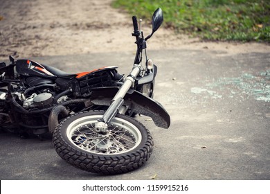 Broken Motorcycle On The Road After Traffic Incident