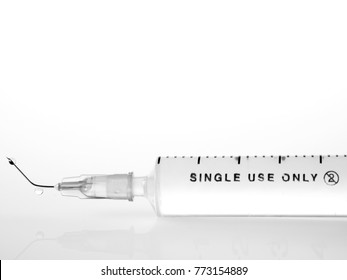 Broken Needle And Syringe On White Background