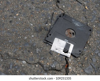 Broken and obsolete floppy disk on the ground