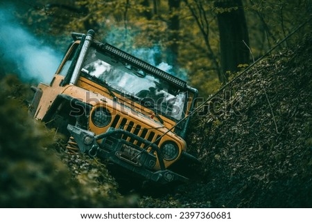 A broken off-road vehicle being pulled out of a ditch with a winch.