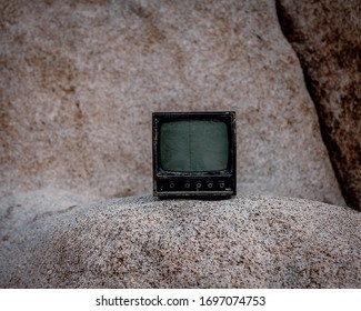 A broken old mini television sitting in Joshua Tree desert