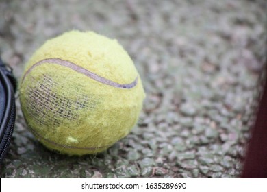 broken old tennis ball on the ground - Powered by Shutterstock