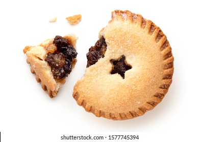 Broken open traditional british christmas mince pie with fruit filling isolated on white. Top view.