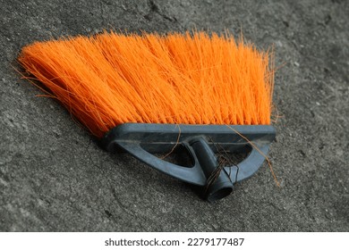 broken orange plastic broom on the floor. - Shutterstock ID 2279177487