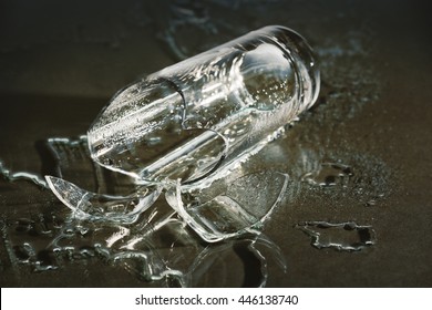 Broken overturned glass on gray background - Powered by Shutterstock