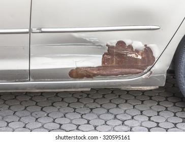 Broken Part Of Car Body With Rusty  On Concrete Floor