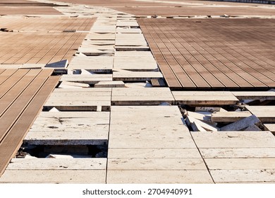 Broken paving creating an uneven surface, depicting neglect, construction issues, maintenance problems, and potential danger