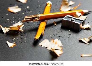 Broken pencil with metal sharpener and shavings on black background. Horizontal image. - Powered by Shutterstock